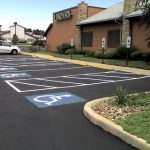 Parking lot pavement line marking includes ADA compliant disabled parking spaces.