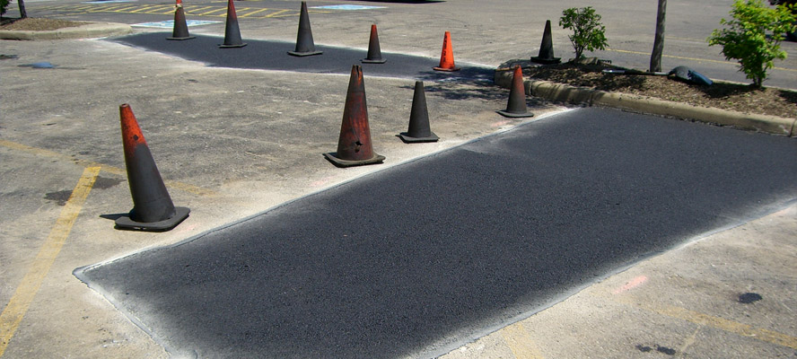An example of our parking lot asphalt patching and repair.